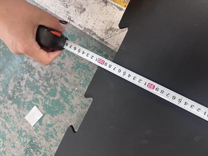 A cross-section diagram showing how a thick, dense interlocking mat protects the subfloor from a dropped weight.